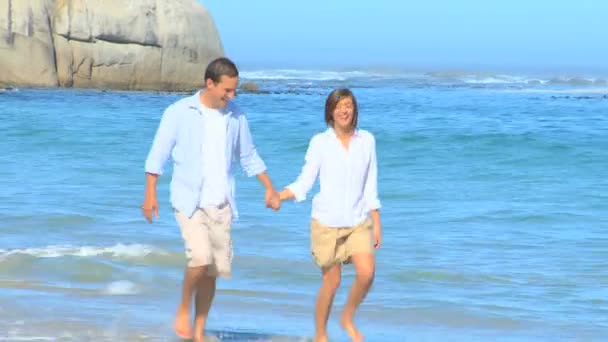 幸福的情侣在沙滩上散步 — 图库视频影像