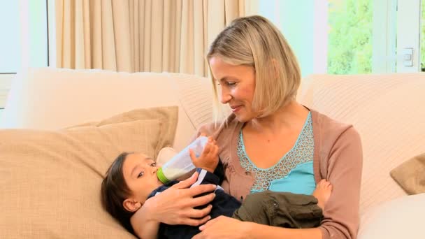 Woman bottle-feeding her son — Stock Video