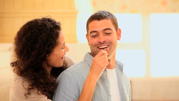 Woman taunting her boyfriend with a strawberry — Stock Video