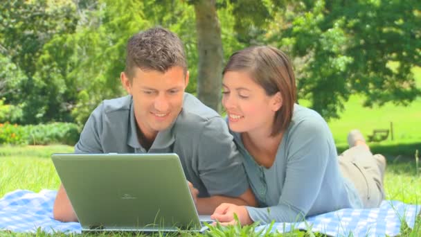 Young couple using their laptop — Stock Video