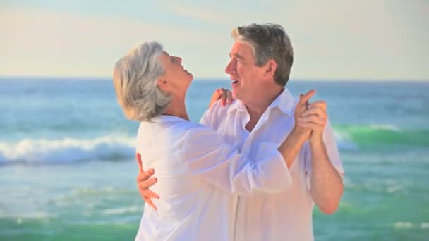 Mature couple dancing on a beach — Stock Video