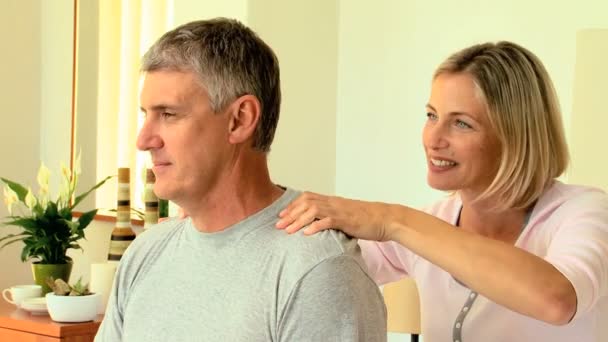 Woman massaging her husband's shoulders — Stock Video