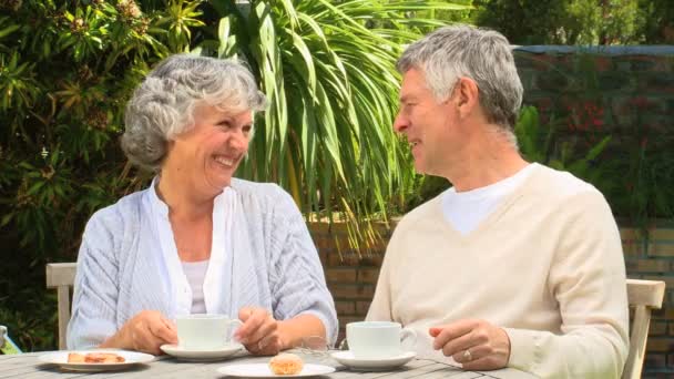 Couple d'âge mûr prenant un café dans le jardin — Video