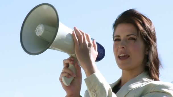 Businesswoman giving instruction via megaphone — Stock Video