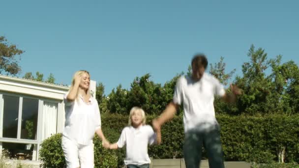 Rodzice i dziecko skoki na trampolinie — Wideo stockowe