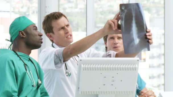 Три врача обсуждают компьютерную томографию — стоковое видео