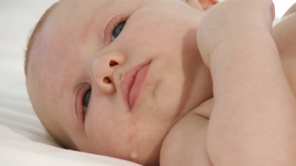 Kleines Baby liegt auf einem Bett — Stockvideo