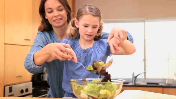 Mère et fille mélangeant une salade — Video