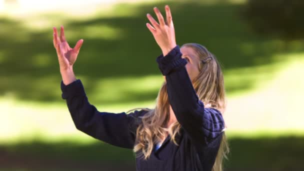 Blonde woman throwing leaves in slow motion — Stock Video