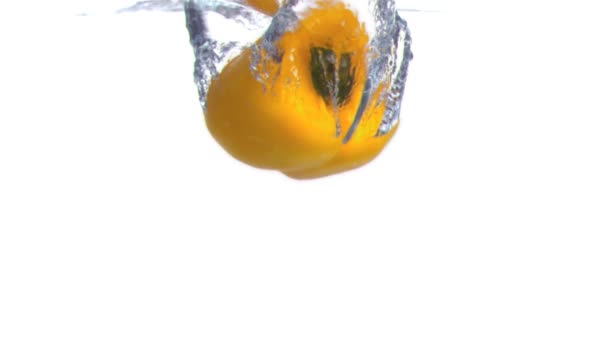 Pepper submerged into water in super slow motion — Stock Video