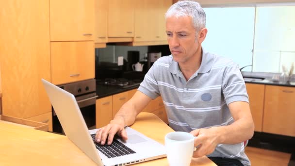 Smiling man using a laptop — Stock Video