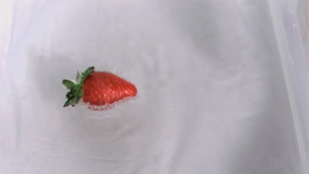 Strawberry falling into water in super slow motion — Stock Video