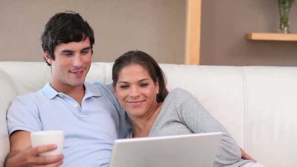 Happy couple looking at a laptop — Stock Video