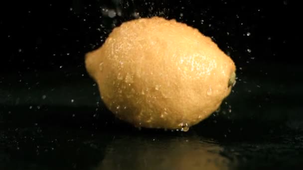 Water sprayed on lemon in super slow motion — Stock Video