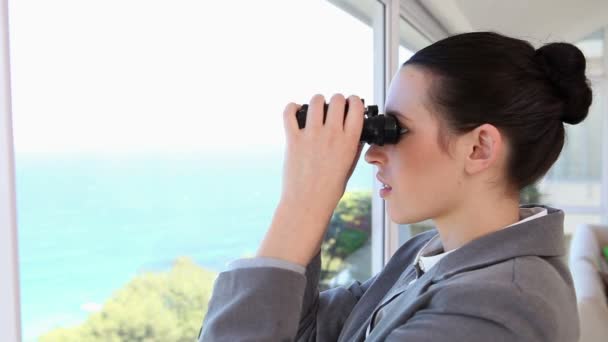 Businesswoman looking through a binoculars — Stock Video