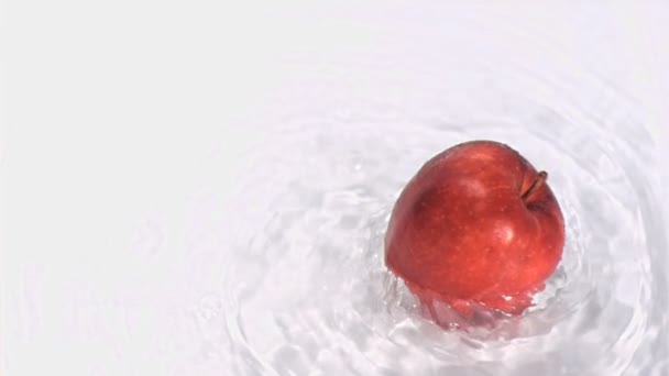 Apple turning in water in super slow motion — Stock Video