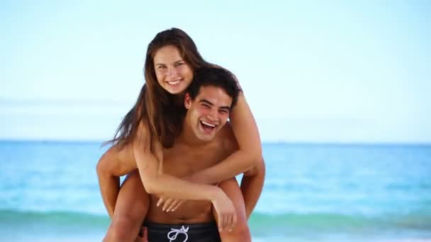 Man giving his girlfriend a piggy-back — Stock Video