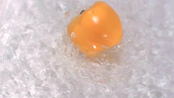 Pepper turning in water in super slow motion — Stock Video