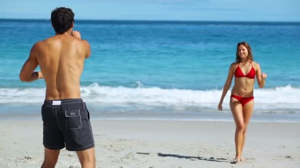 Sonriente pareja jugando frisbee — Vídeo de stock