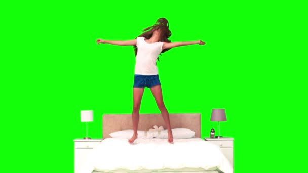 Donna che salta sul letto al rallentatore — Video Stock