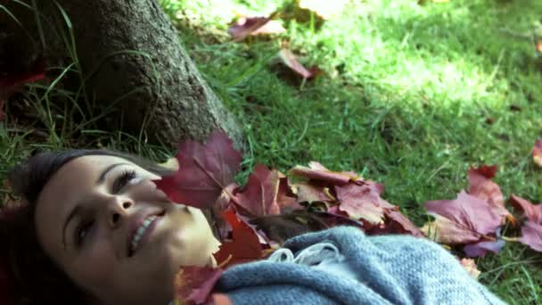 Brunette lying on grass in slow motion — Stock Video