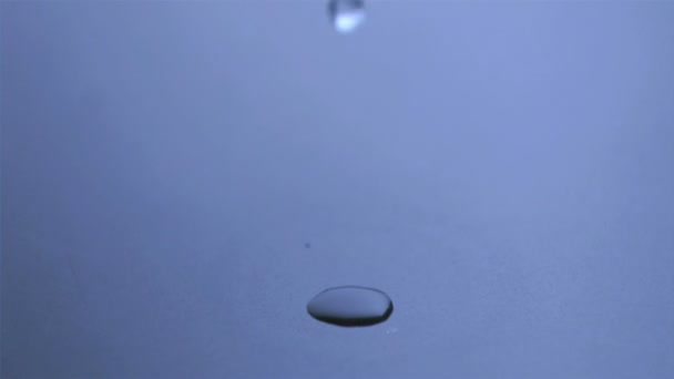 Raindrop in super slow motion falling in a puddle — Stock Video