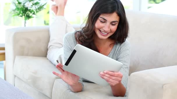 女人微笑的同时使用她平板电脑 — 图库视频影像