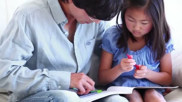 Father helping his daughter to do her homework — Stock Video