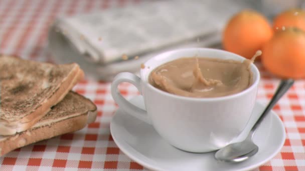 Sugar lump in super slow motion falling in a cup of coffee — Stock Video