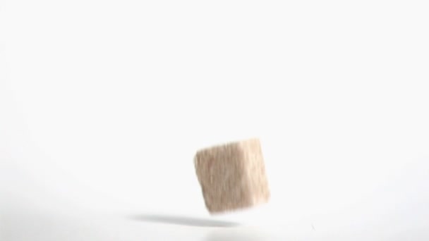 Brown sugar cube falling in super slow motion — Stock Video