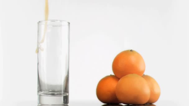 Orange juice splashing in super slow motion — Stock Video