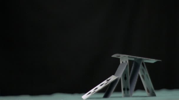 Pyramid of cards collapsing in super slow motion — Stock Video