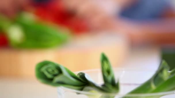 Girl cutting peppers with a parent — Stock Video