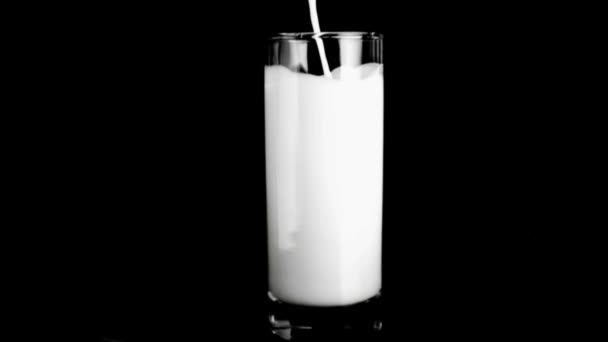 Mjölk fylla ett glas i super slow motion — Stockvideo