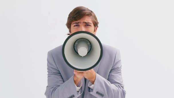 Serious businessman talking into a megaphone — Stock Video