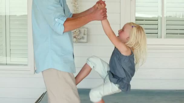 Father helping his daughter do a back flip — Stock Video