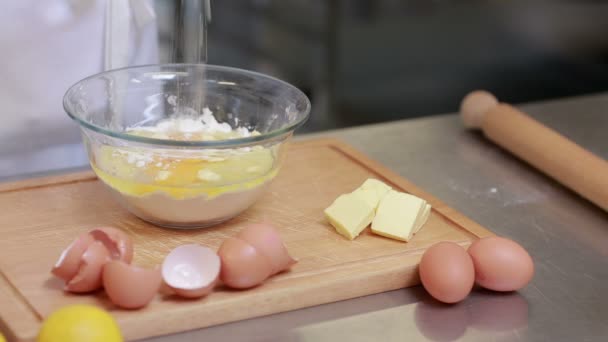 Cook standing at a counter and preparing dough — Stock Video