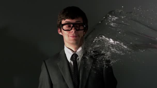 Man in suit being splashed with water — Stock Video