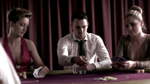 Man playing poker with two girls — Stock Video