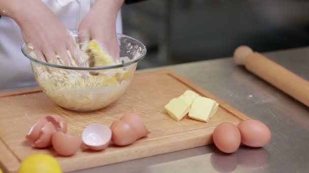 Cook kneading dough in a kitchen — Stock Video