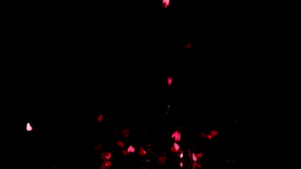 Heart confetti falling down on black background — Stock Video