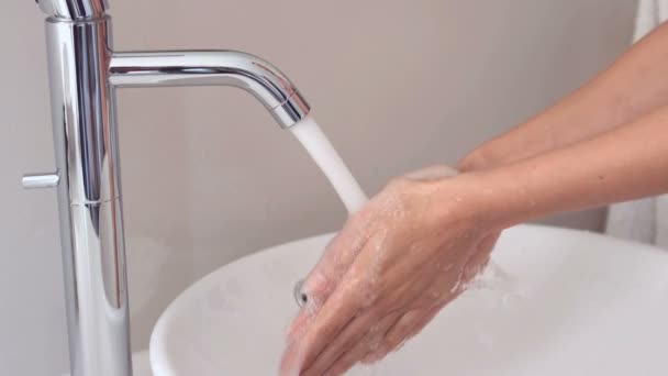 Iemand wassen hun handen op de gootsteen in badkamer — Stockvideo