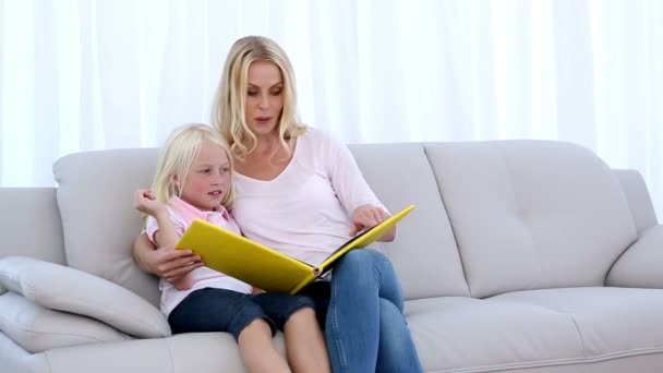 Мати і дочка читають книгу — стокове відео