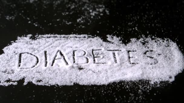 Diabetes spelled out in sugar blowing away — Stock Video