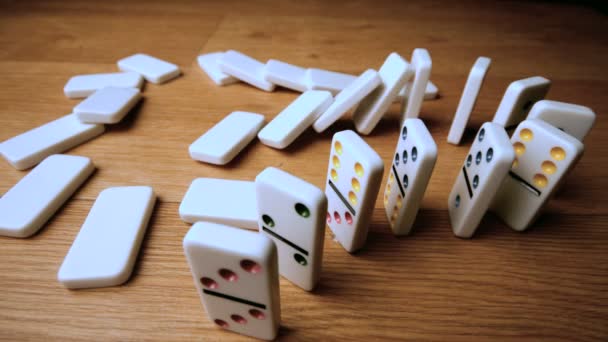 The domino effect on wooden table high angle shot — Stock Video