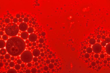 Kırmızı zemin üzerinde şeffaf olmayan hava kabarcıkları tarafından oluşturulan desenli desen.