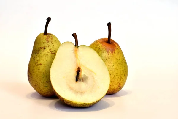 The picture shows ripe pears whole and half.