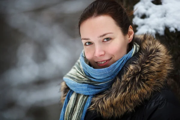 Mujer en la nieve bosque de invierno con cuello y bufanda azul — Foto de Stock