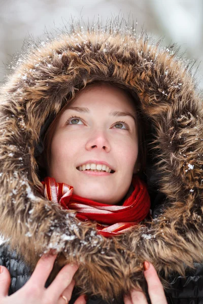 Woman in snow winter forest with neckpiece and red scarf smiling — Stock Photo, Image