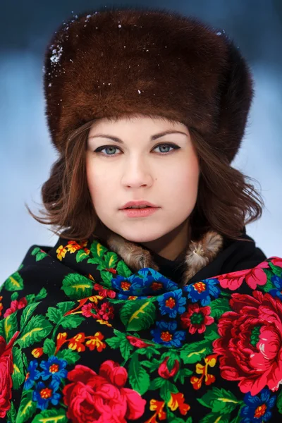 Young beautiful woman in fur hats in winter forest — Stock Photo, Image